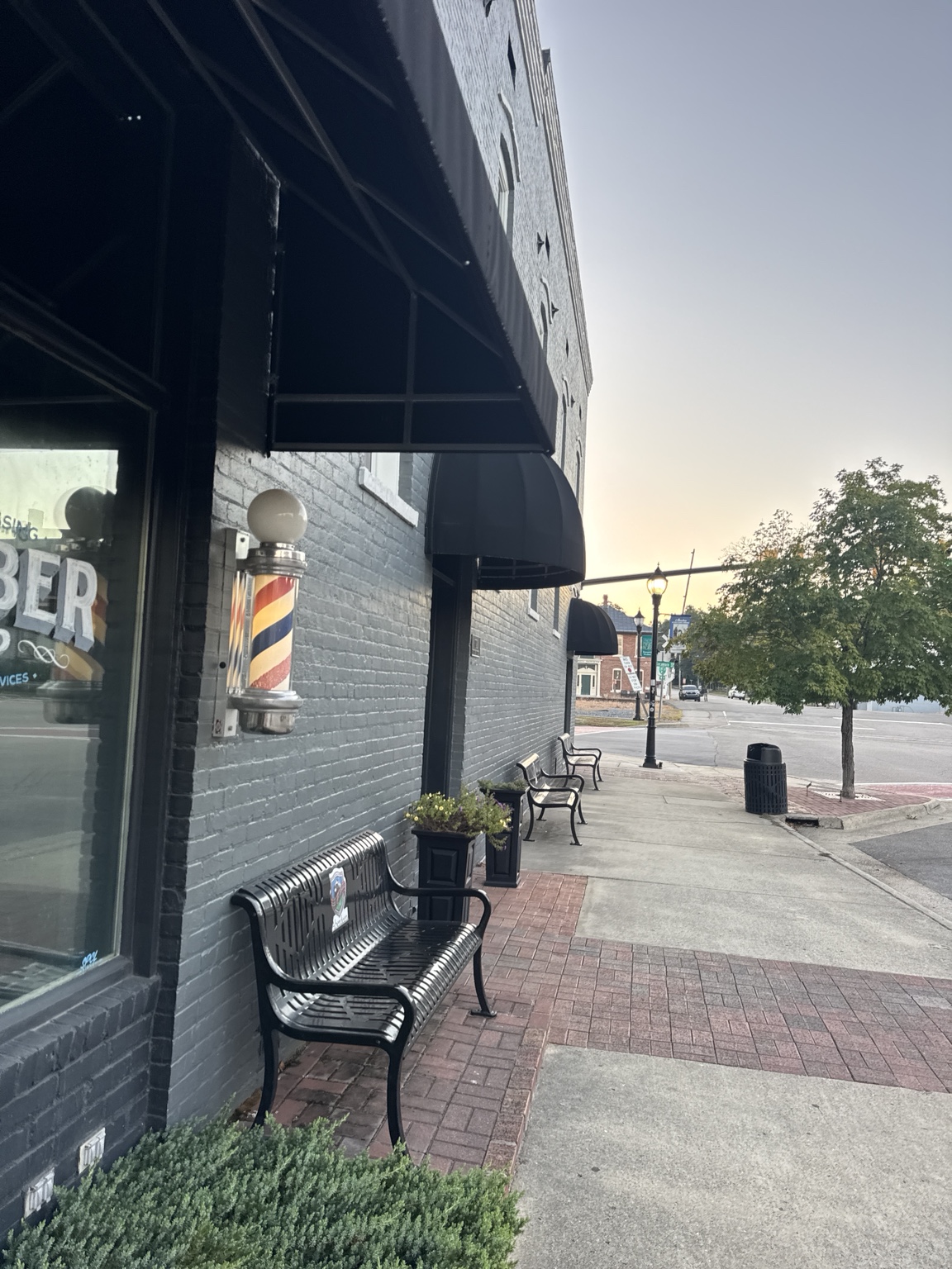 Barber pole and benches along a downtown Aberdeen storefront