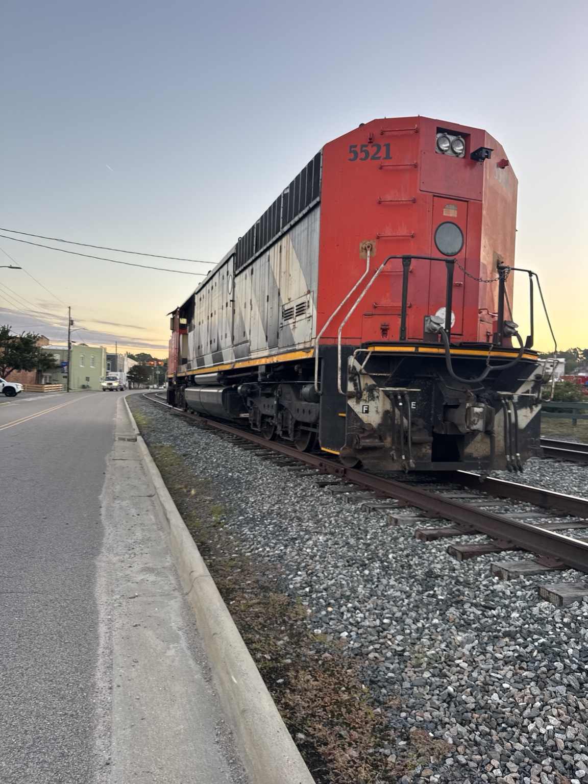 Red locomotive passing along the tracks through Aberdeen
