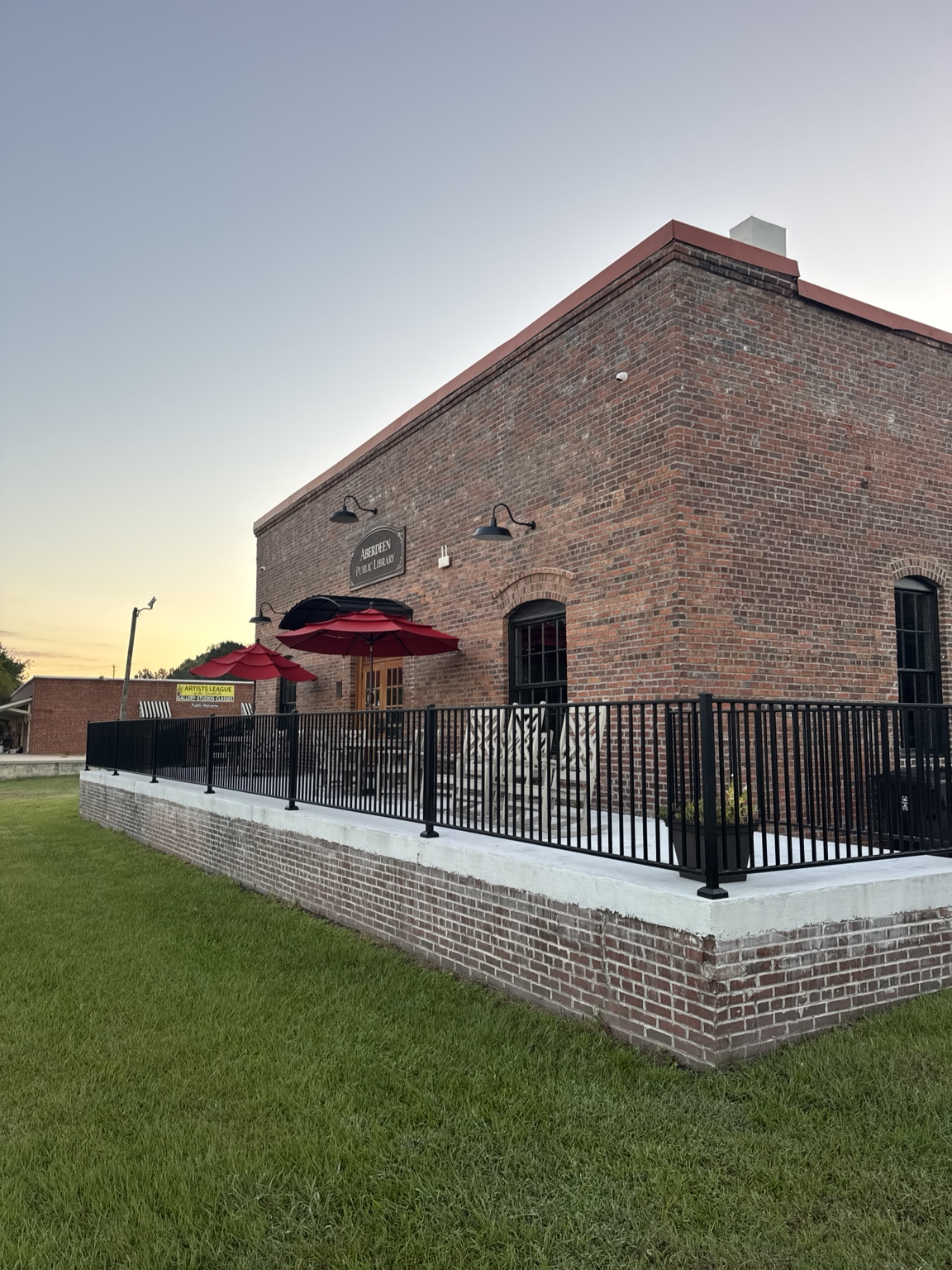 Brick public library patio with red umbrellas in Aberdeen